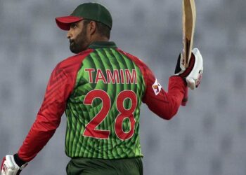 Bangladesh's Tamim Iqbal raises his bat to celebrate scoring fifty runs during the first match of their Tri-Nation one-day international cricket series against Zimbabwe in Dhaka, Bangladesh, Monday, Jan. 15, 2018. (AP Photo/A.M. Ahad)