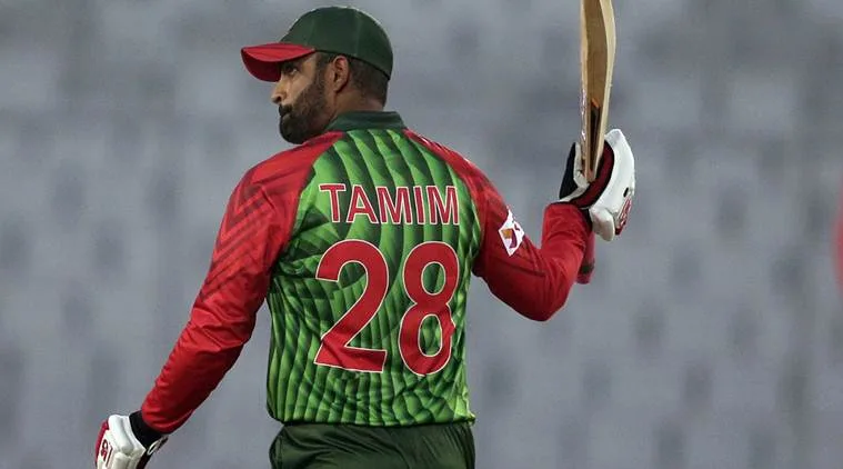 Bangladesh's Tamim Iqbal raises his bat to celebrate scoring fifty runs during the first match of their Tri-Nation one-day international cricket series against Zimbabwe in Dhaka, Bangladesh, Monday, Jan. 15, 2018. (AP Photo/A.M. Ahad)