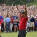 Tiger Woods celebrates after picking up his putt for par on the 18th green to win the final round of the Tour Championship golf tournament Sunday, Sept. 23, 2018, in Atlanta. (Hyosub Shin/Atlanta Journal-Constitution via AP)