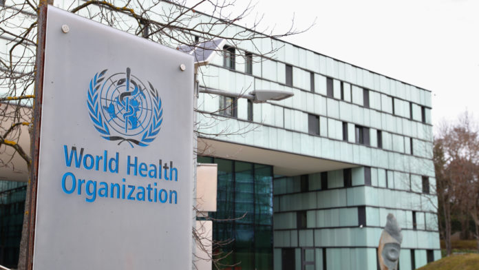 A logo is pictured outside a building of the WHO in Geneva