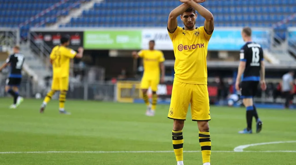PADERBORN, GERMANY - MAY 31: Achraf Hakimi Mouh of Borussia Dortmund celebrates scoring his teams fourth goal of the game during the Bundesliga match between SC Paderborn 07 and Borussia Dortmund at Benteler Arena on May 31, 2020 in Paderborn, Germany. (Photo by Lars Baron/Getty Images)