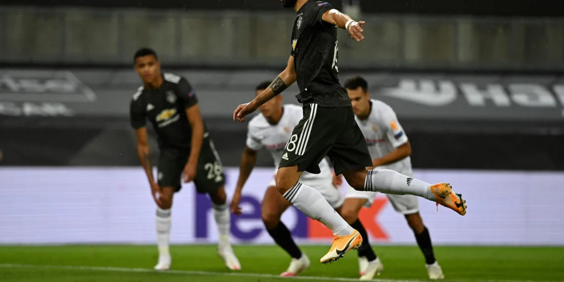 Manchester United's Portuguese midfielder Bruno Fernandes scores the opening goal from the penalty spot during the UEFA Europa League semi-final football match Sevilla v Manchester United on August 16, 2020 in Cologne, western Germany. (Photo by Ina Fassbender / POOL / AFP) (Photo by INA FASSBENDER/POOL/AFP via Getty Images)