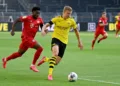 Dortmund's Norwegian forward Erling Braut Haaland (R) and Bayern Munich's Canadian midfielder Alphonso Davies vie for the ball during the German first division Bundesliga football match BVB Borussia Dortmund v FC Bayern Munich on May 26, 2020 in Dortmund, western Germany. (Photo by Federico GAMBARINI / POOL / AFP) / DFL REGULATIONS PROHIBIT ANY USE OF PHOTOGRAPHS AS IMAGE SEQUENCES AND/OR QUASI-VIDEO (Photo by FEDERICO GAMBARINI/POOL/AFP via Getty Images)