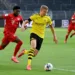 Dortmund's Norwegian forward Erling Braut Haaland (R) and Bayern Munich's Canadian midfielder Alphonso Davies vie for the ball during the German first division Bundesliga football match BVB Borussia Dortmund v FC Bayern Munich on May 26, 2020 in Dortmund, western Germany. (Photo by Federico GAMBARINI / POOL / AFP) / DFL REGULATIONS PROHIBIT ANY USE OF PHOTOGRAPHS AS IMAGE SEQUENCES AND/OR QUASI-VIDEO (Photo by FEDERICO GAMBARINI/POOL/AFP via Getty Images)