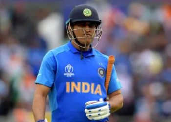 India's Mahendra Singh Dhoni walks off for 50 during the 2019 Cricket World Cup first semi-final between New Zealand and India at Old Trafford in Manchester, northwest England, on July 10, 2019. (Photo by Dibyangshu Sarkar / AFP) / RESTRICTED TO EDITORIAL USE