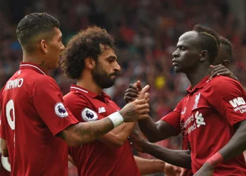 Liverpool's Senegalese striker Sadio Mané (R) celebrates with teammates after scoring their third goal during the English Premier League football match between Liverpool and West Ham United at Anfield in Liverpool, north west England on August 12, 2018. (Photo by Oli SCARFF / AFP) / RESTRICTED TO EDITORIAL USE. No use with unauthorized audio, video, data, fixture lists, club/league logos or 'live' services. Online in-match use limited to 120 images. An additional 40 images may be used in extra time. No video emulation. Social media in-match use limited to 120 images. An additional 40 images may be used in extra time. No use in betting publications, games or single club/league/player publications. /         (Photo credit should read OLI SCARFF/AFP/Getty Images)