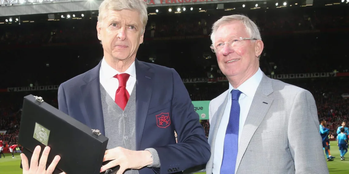 MANCHESTER, ENGLAND - APRIL 29: Former manager Sir Alex Ferguson of Manchester United presents Manager Arsene Wenger of Arsenal with a gift to mark his retirement ahead of the Premier League match between Manchester United and Arsenal at Old Trafford on April 29, 2018 in Manchester, England. (Photo by John Peters/Man Utd via Getty Images) *** Local Caption *** Arsene Wenger; Alex Ferguson
