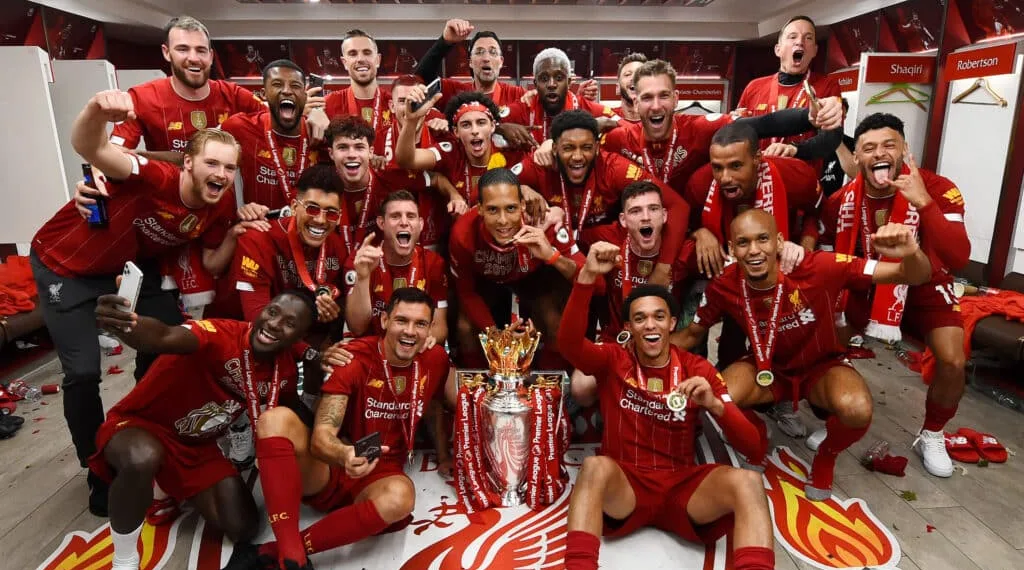 LIVERPOOL, ENGLAND - JULY 22: (THE SUN OUT, THE SUN ON SUNDAY OUT) Trent Alexander-Arnold, Georginio Wijnaldum, Naby Keita, Roberto Firmino, Alex Oxlade-Chamberlain, Fabinho, Andy Robertson, Virgil van Dijk, James Milner, Joe Gomez, Curtis Jones, Adrian, Divock Origi, Adam Lallana, Harvey Elliott, Joel Matip, Xherdan Shaqiri, Jordan Henderson captain of Liverpool and Jurgen Klopp manager of Liverpool celebrating in the dressing room with the premier league trophy after winning the Premier league at the end of the Premier League match between Liverpool FC and Chelsea FC at Anfield on July 22, 2020 in Liverpool, England. Football Stadiums around Europe remain empty due to the Coronavirus Pandemic as Government social distancing laws prohibit fans inside venues resulting in all fixtures being played behind closed doors. (Photo by Andrew Powell/Liverpool FC via Getty Images)