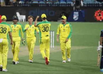 Australian players celebrate the wicket of Indian batsmen.