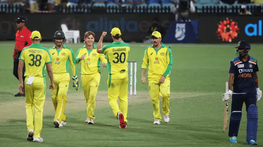Australian players celebrate the wicket of Indian batsmen.