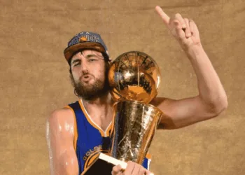 Andrew Bogut poses with his only NBA Championship trophy.