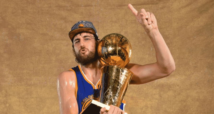 Andrew Bogut poses with his only NBA Championship trophy.