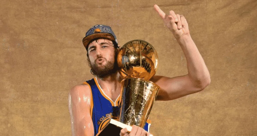 Andrew Bogut poses with his only NBA Championship trophy.