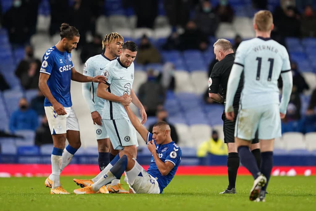 LIVERPOOL, ENGLAND - DECEMBER 12: Richarlison of Everton is assisted by Mateo Kovacic of Chelsea during the Premier League match between Everton and Chelsea at Goodison Park on December 12, 2020 in Liverpool, England. A limited number of spectators (2000) are welcomed back to stadiums to watch elite football across England. This was following easing of restrictions on spectators in tiers one and two areas only. (Photo by Jon Super - Pool/Getty Images)