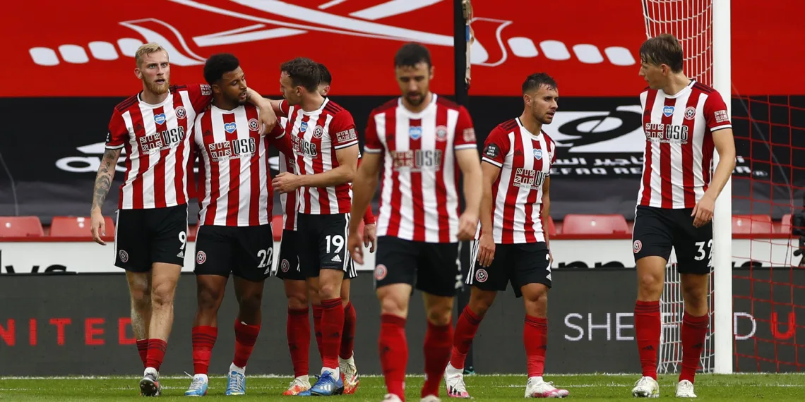 SHEFFIELD, ENGLAND - JULY 02: Lys Mousset of Sheffield United celebrates with Oliver McBurnie and Jack Robinson after scoring his team's second goal during the Premier League match between Sheffield United and Tottenham Hotspur at Bramall Lane on July 02, 2020 in Sheffield, England. Football Stadiums around Europe remain empty due to the Coronavirus Pandemic as Government social distancing laws prohibit fans inside venues resulting in all fixtures being played behind closed doors. (Photo by Jason Cairnduff/Pool via Getty Images)