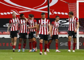 SHEFFIELD, ENGLAND - JULY 02: Lys Mousset of Sheffield United celebrates with Oliver McBurnie and Jack Robinson after scoring his team's second goal during the Premier League match between Sheffield United and Tottenham Hotspur at Bramall Lane on July 02, 2020 in Sheffield, England. Football Stadiums around Europe remain empty due to the Coronavirus Pandemic as Government social distancing laws prohibit fans inside venues resulting in all fixtures being played behind closed doors. (Photo by Jason Cairnduff/Pool via Getty Images)