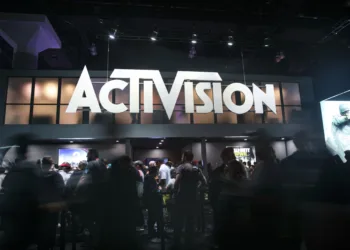 Attendees walk past Activision Blizzard Inc. signage during the E3 Electronic Entertainment Expo in Los Angeles, California, U.S., on Wednesday, June 14, 2017. Photographer: Patrick T. Fallon/Bloomberg