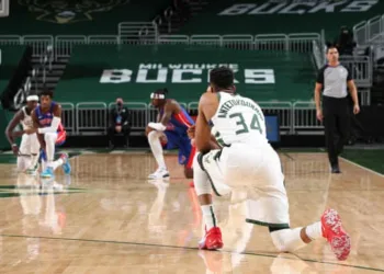 NBA players kneel down during their match.