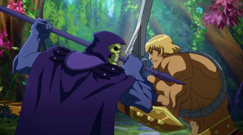 In a CG animated still from Masters of the Universe: Revelation, Skeletor (left), who wears a purple cloak and hood over his skull, grips his spear in a battle against He-Man (right), a strong shirtless blonde male with a golden armored belt and wrist plates holding a silver sword. The two are standing face to face in a forest with bright foliage.