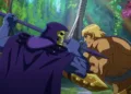 In a CG animated still from Masters of the Universe: Revelation, Skeletor (left), who wears a purple cloak and hood over his skull, grips his spear in a battle against He-Man (right), a strong shirtless blonde male with a golden armored belt and wrist plates holding a silver sword. The two are standing face to face in a forest with bright foliage.