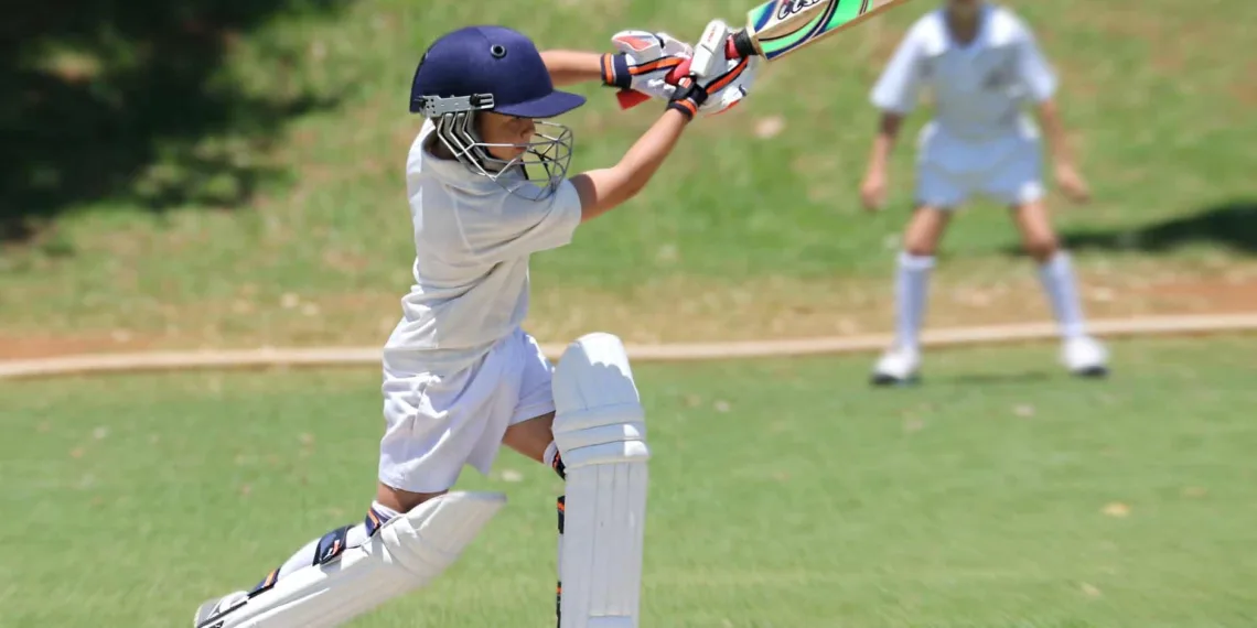 man in white jersey shirt and pants holding cricket bat