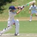 man in white jersey shirt and pants holding cricket bat