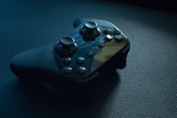 black wireless game controller on black leather
