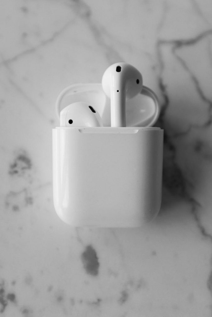 monochrome photo of apple airpods