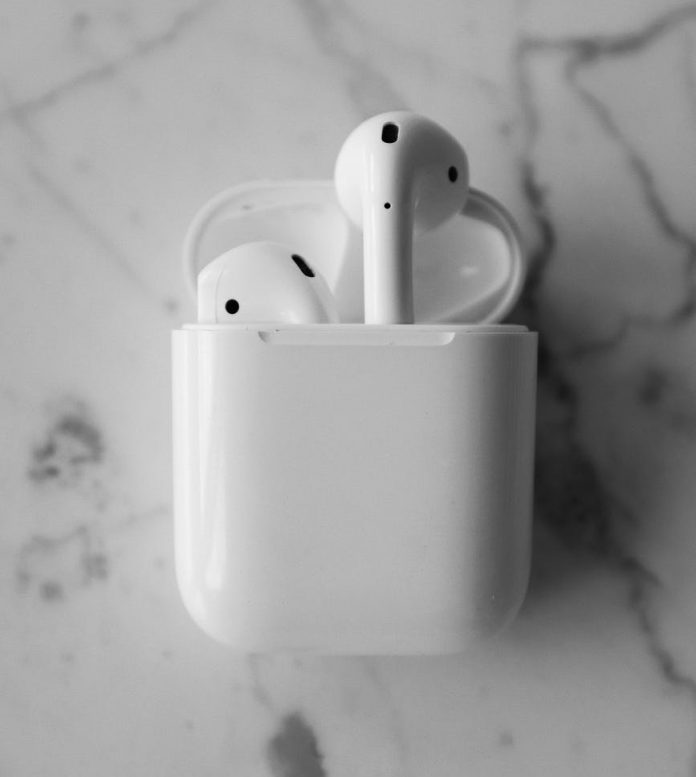 monochrome photo of apple airpods