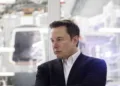 Elon Musk, chief executive officer of Space Exploration Technologies Corp. (SpaceX) and Tesla Inc., listens as Jim Bridenstine, administrator of the U.S. National Aeronautics and Space Administration (NASA), not pictured, speaks during an event at SpaceX headquarters in Hawthorne, California, U.S., on Thursday, Oct. 10, 2019. SpaceXs Elon Musk and NASA Administrator Jim Bridenstine staged a public show of support for one another at the rocket companys headquarters Thursday, weeks after the two traded barbs over the closely held companys delayed efforts to fly astronauts for the first time. Photographer: Patrick T. Fallon/Bloomberg via Getty Images