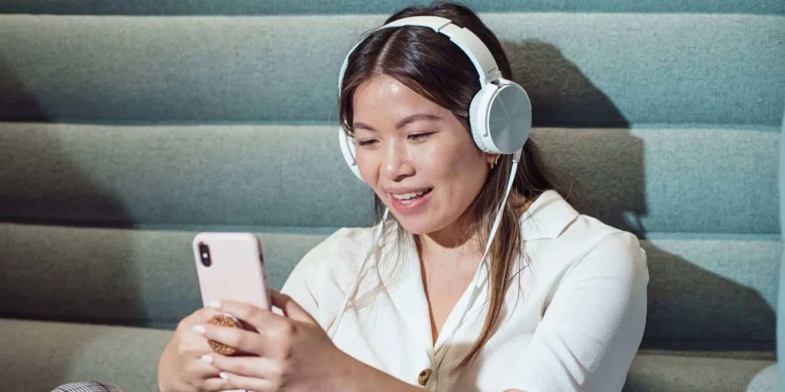 woman using smartphone while listening to music