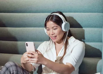 woman using smartphone while listening to music