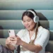 woman using smartphone while listening to music