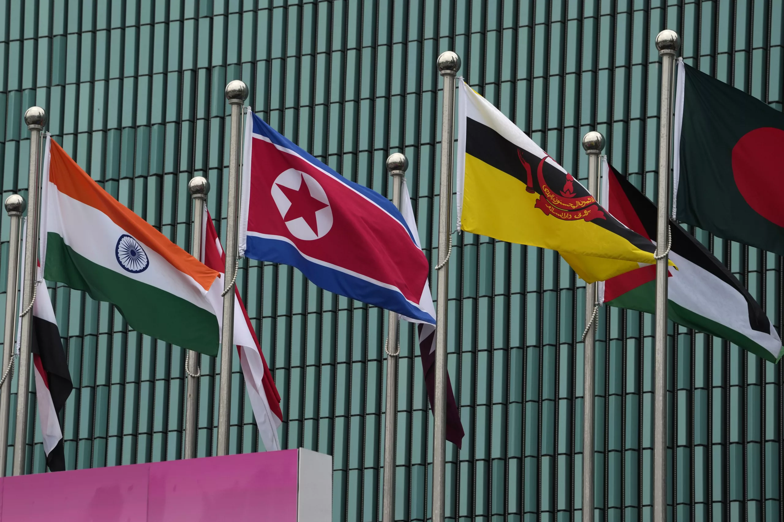 Flags of participating countries, among them North Korea, India, and Brunei, are hoisted at the Athletes Village at the 19th Asian Games in Hangzhou, China, Thursday, Sept. 21, 2023. (AP Photo/Ng Han Guan)