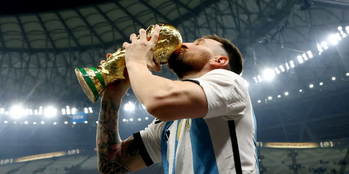 Soccer Football - FIFA World Cup Qatar 2022 - Final - Argentina v France - Lusail Stadium, Lusail, Qatar - December 18, 2022   Argentina's Lionel Messi kisses the trophy as he celebrates winning the World Cup REUTERS/Hannah Mckay