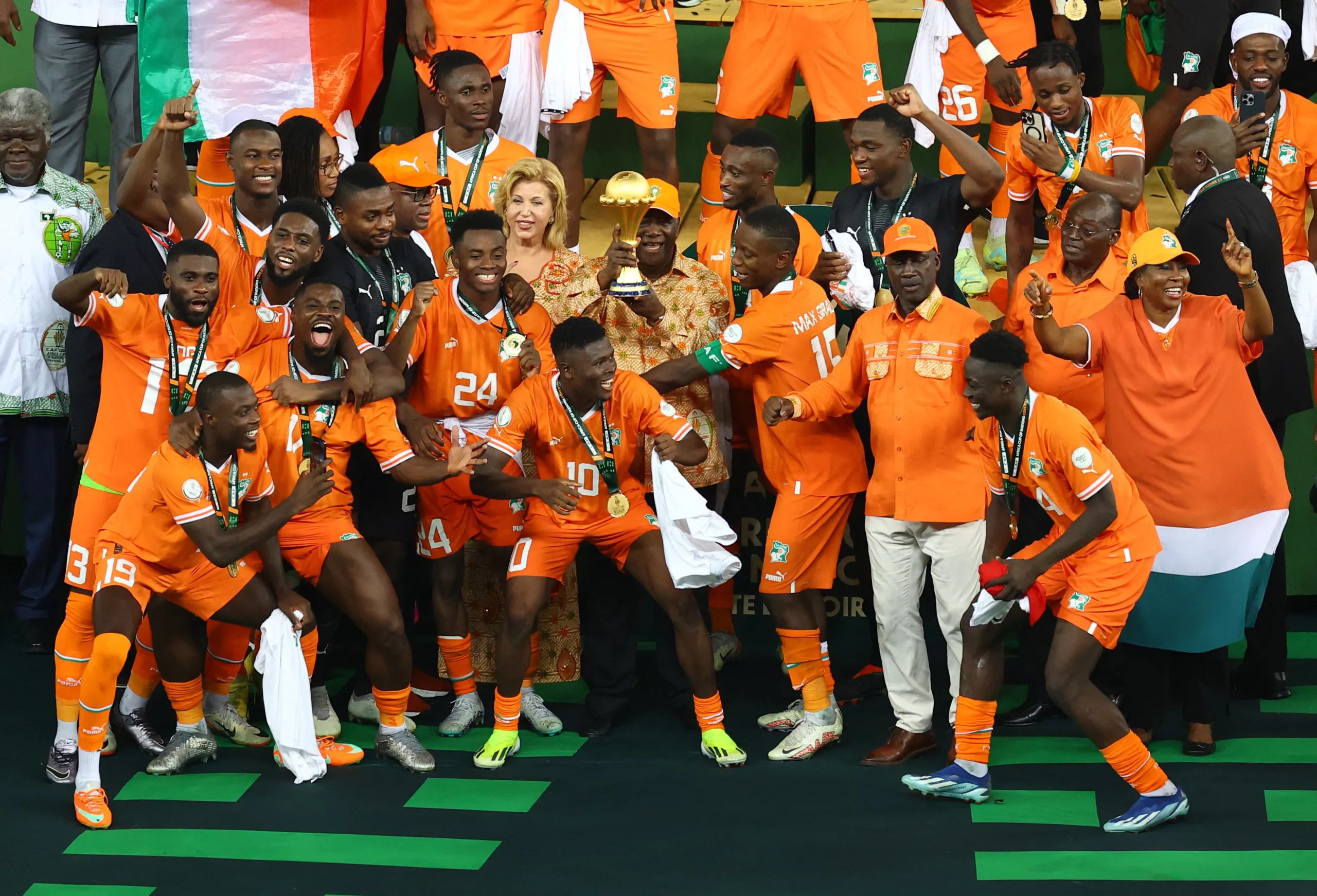 Soccer Football - Africa Cup of Nations - Final - Nigeria v Ivory Coast - Stade Olympique Alassane Ouattara, Abidjan, Ivory Coast - February 11, 2024 Ivory Coast president Alassane Ouattara with the trophy alongside the players as they celebrate after winning the Africa Cup of Nations REUTERS/Siphiwe Sibeko