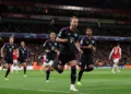 Soccer Football - Champions League - Quarter Final - First Leg - Arsenal v Bayern Munich - Emirates Stadium, London, Britain - April 9, 2024 Bayern Munich's Harry Kane celebrates scoring their second goal with Jamal Musiala and Serge Gnabry REUTERS/David Klein