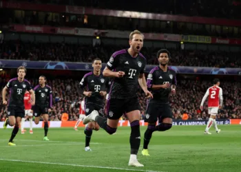 Soccer Football - Champions League - Quarter Final - First Leg - Arsenal v Bayern Munich - Emirates Stadium, London, Britain - April 9, 2024 Bayern Munich's Harry Kane celebrates scoring their second goal with Jamal Musiala and Serge Gnabry REUTERS/David Klein