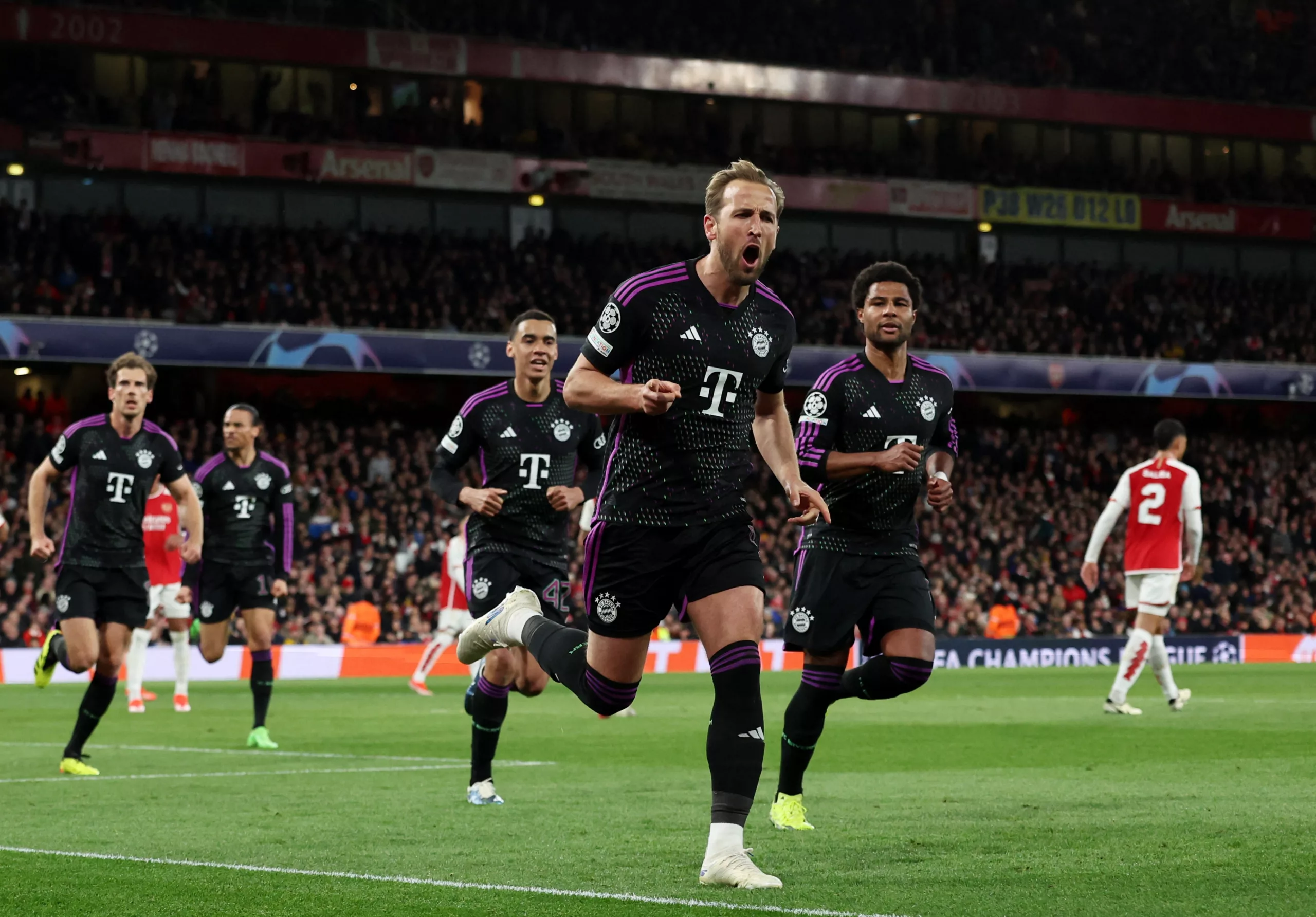 Soccer Football - Champions League - Quarter Final - First Leg - Arsenal v Bayern Munich - Emirates Stadium, London, Britain - April 9, 2024 Bayern Munich's Harry Kane celebrates scoring their second goal with Jamal Musiala and Serge Gnabry REUTERS/David Klein