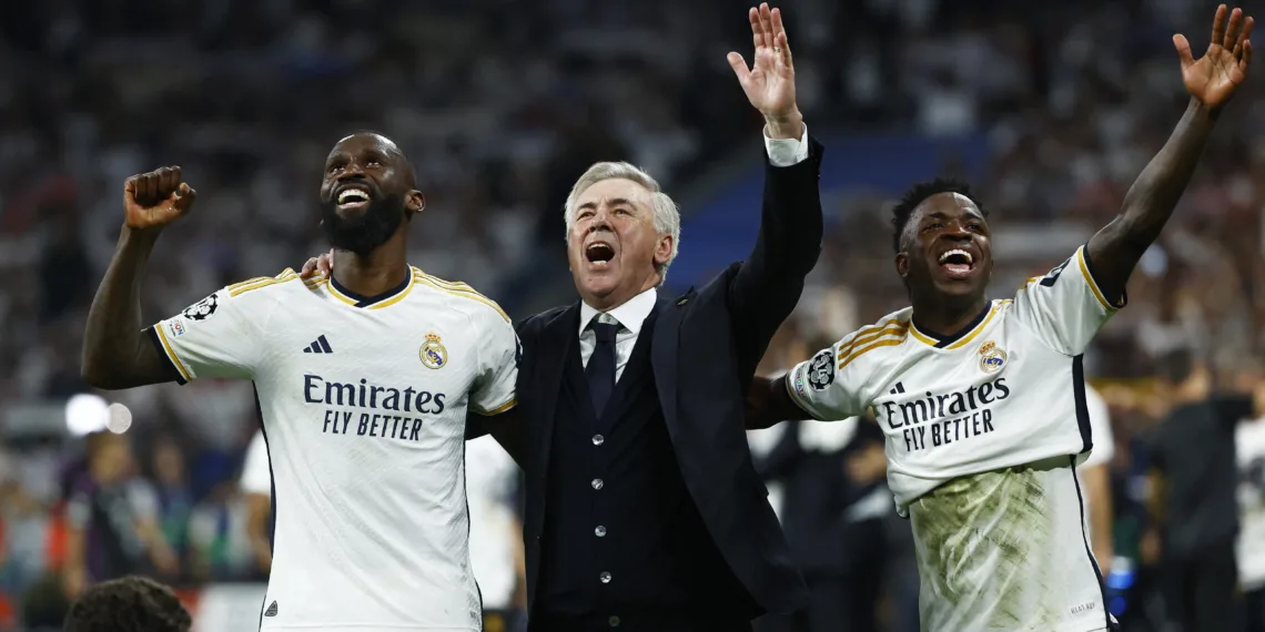 Soccer Football - Champions League - Semi Final - Second Leg - Real Madrid v Bayern Munich - Santiago Bernabeu, Madrid, Spain - May 8, 2024  Real Madrid's Antonio Rudiger, coach Carlo Ancelotti and Vinicius Junior celebrate after the match REUTERS/Susana Vera
