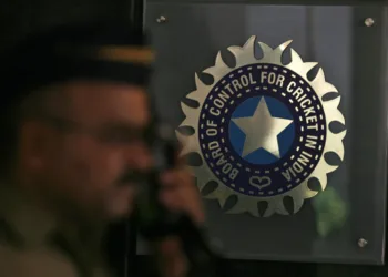 A policeman walks past a logo of the Board of Control for Cricket in India (BCCI) during a governing council meeting of the Indian Premier League (IPL) at BCCI headquarters in Mumbai April 26, 2010. Indian Premier League chief Lalit Modi has been suspended, officials said on Monday, after graft accusations in cricket's richest event ensnared top politicians and Bollywood stars and strained the ruling coalition.  REUTERS/Arko Datta (INDIA - Tags: SPORT CRICKET)