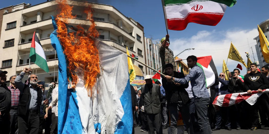 FILE PHOTO: Iranians burn an Israeli flag during a rally marking Quds Day and the funeral of members of the Islamic Revolutionary Guard Corps who were killed in a suspected Israeli airstrike on the Iranian embassy complex in the Syrian capital Damascus, in Tehran, Iran, April 5, 2024. Majid Asgaripour/WANA (West Asia News Agency) via REUTERS/File Photo