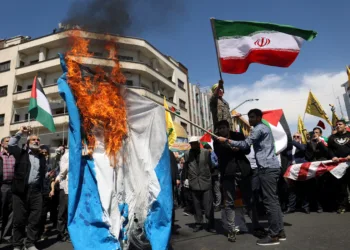 FILE PHOTO: Iranians burn an Israeli flag during a rally marking Quds Day and the funeral of members of the Islamic Revolutionary Guard Corps who were killed in a suspected Israeli airstrike on the Iranian embassy complex in the Syrian capital Damascus, in Tehran, Iran, April 5, 2024. Majid Asgaripour/WANA (West Asia News Agency) via REUTERS/File Photo