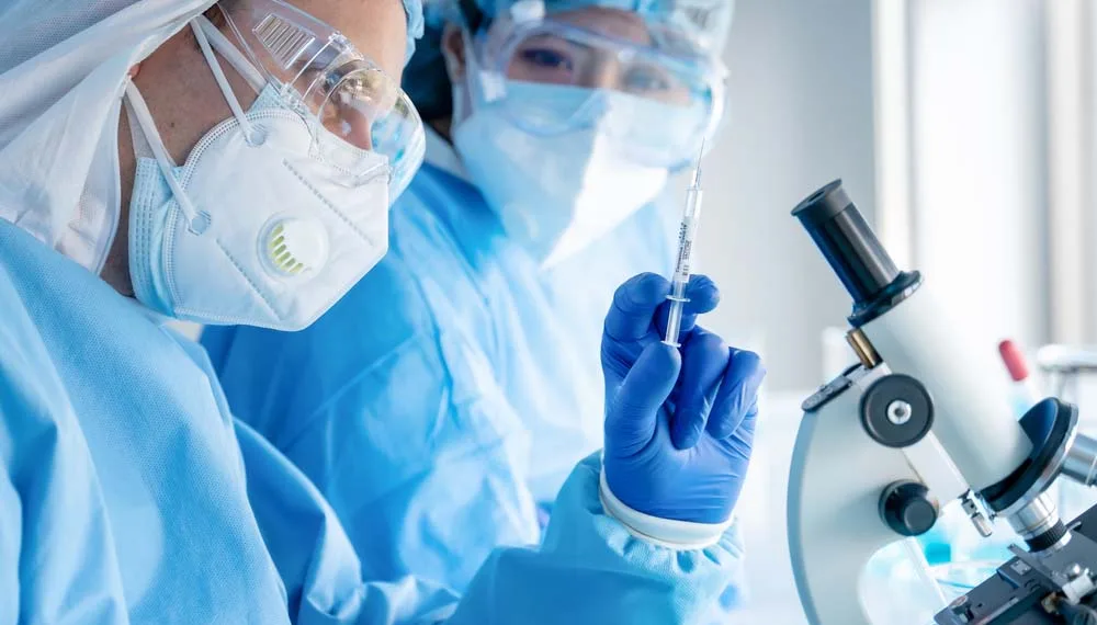 coronavirus covid-19 vaccine in hands of pharmacuetical bio research scientist in vaccine development laboratory, coronavirus covid-19 vaccine development program, selective focused