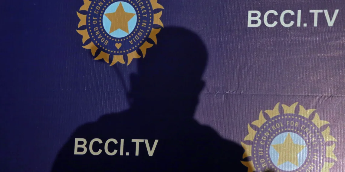 The shadow of a man falls on a backdrop with the logo of the india's cricket board bcci before the start of a news conference to announce its cricket team's coach, in mumbai,