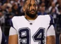 ARLINGTON, TEXAS - DECEMBER 09: Marshawn Kneeland #94 of the Dallas Cowboys looks on from the sideline during the national anthem prior to an NFL football game against the Cincinnati Bengals at AT&T Stadium on December 9, 2024 in Arlington, Texas. (Photo by Perry Knotts/Getty Images)