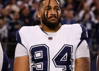ARLINGTON, TEXAS - DECEMBER 09: Marshawn Kneeland #94 of the Dallas Cowboys looks on from the sideline during the national anthem prior to an NFL football game against the Cincinnati Bengals at AT&T Stadium on December 9, 2024 in Arlington, Texas. (Photo by Perry Knotts/Getty Images)